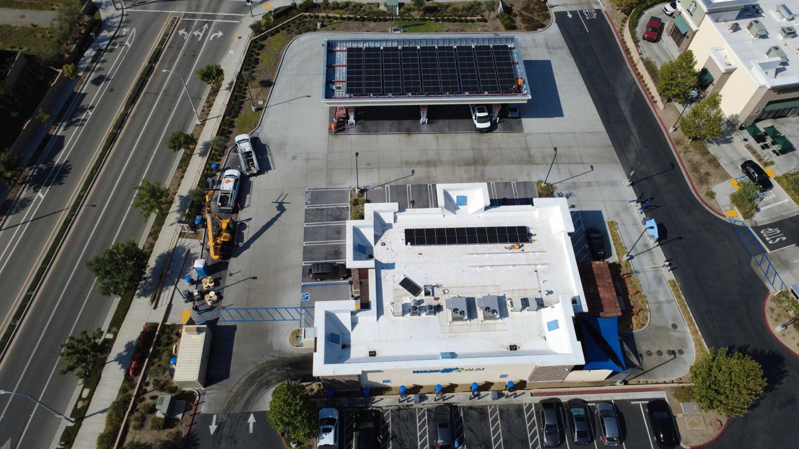 Strobe-controlled facility with solar canopy, rooftop panels, EV chargers, and battery storage